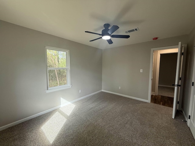 390 W Park St, Vidor, TX 77662 - unfurnished bedroom with baseboards, dark colored carpet, and ceiling fan