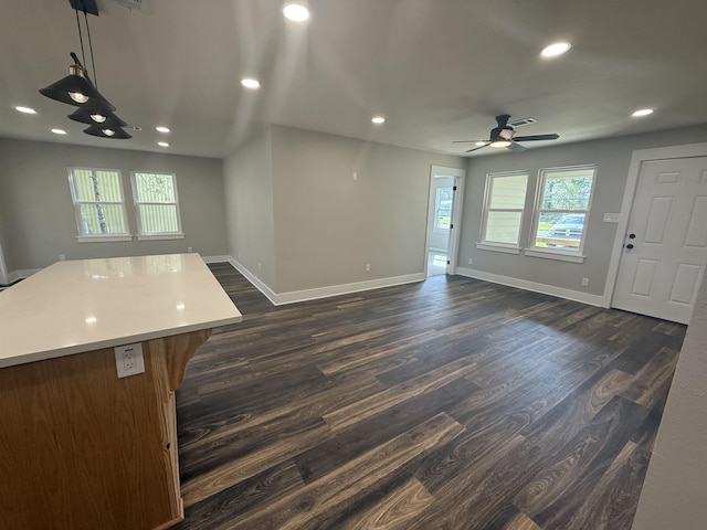 390 W Park St, Vidor, TX 77662 - unfurnished living room featuring baseboards, dark wood-style floors, a ceiling fan, and recessed lighting
