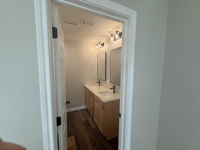 390 W Park St, Vidor, TX 77662 - full bathroom featuring double vanity, wood finished floors, and baseboards
