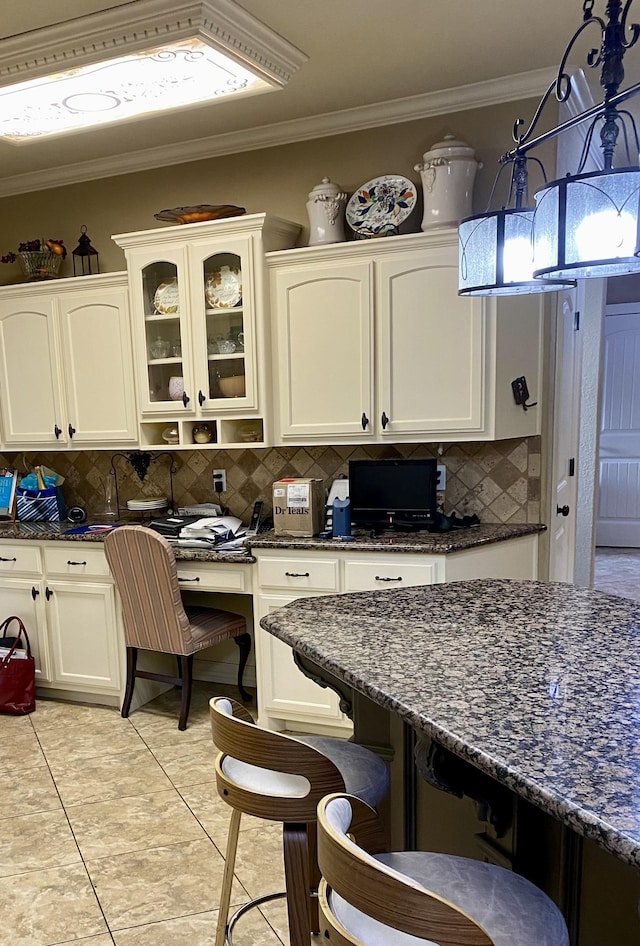 kitchen with decorative backsplash, white cabinetry, and light tile patterned floors