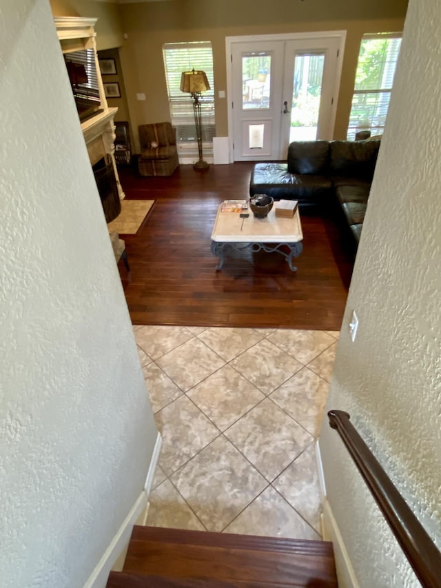 living room with french doors and light hardwood / wood-style floors