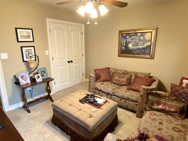 carpeted living room featuring ceiling fan