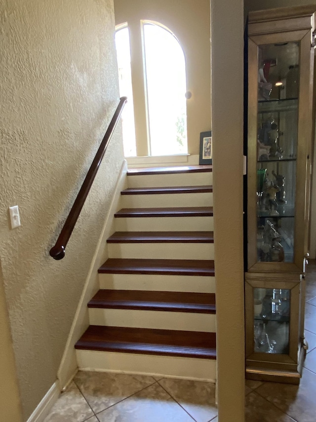 staircase with tile patterned floors