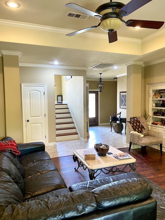 living room with light hardwood / wood-style floors, ceiling fan, and crown molding