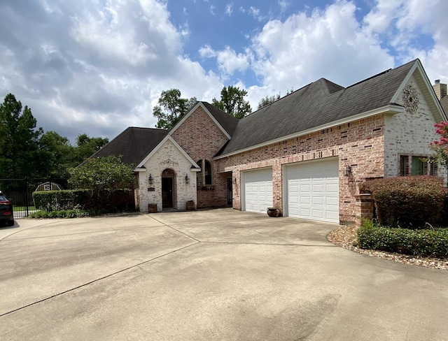 french country style house featuring a garage