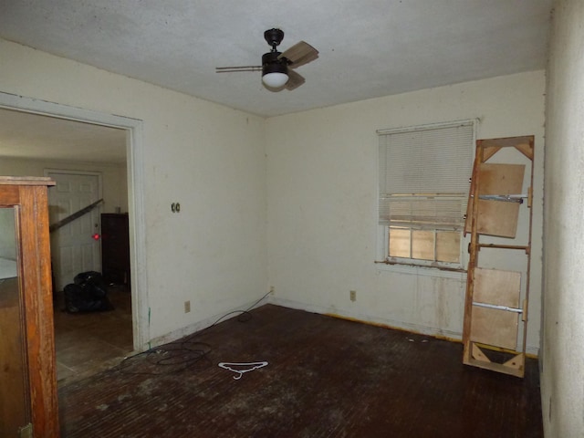 empty room featuring ceiling fan and dark wood-type flooring