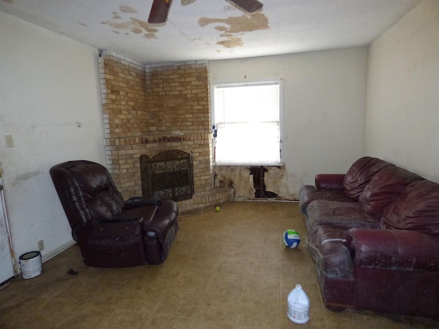 living room featuring ceiling fan and a brick fireplace