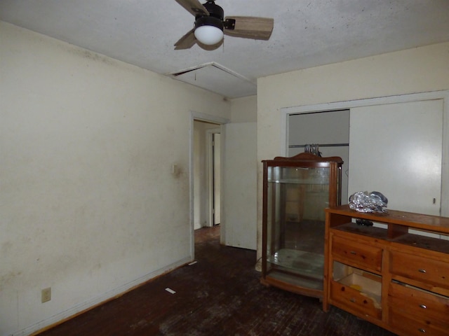 bedroom featuring ceiling fan, a closet, and dark wood-type flooring