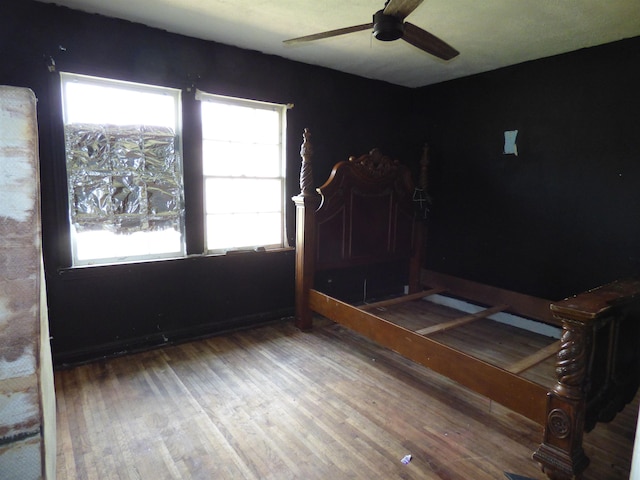 unfurnished bedroom with wood-type flooring and ceiling fan