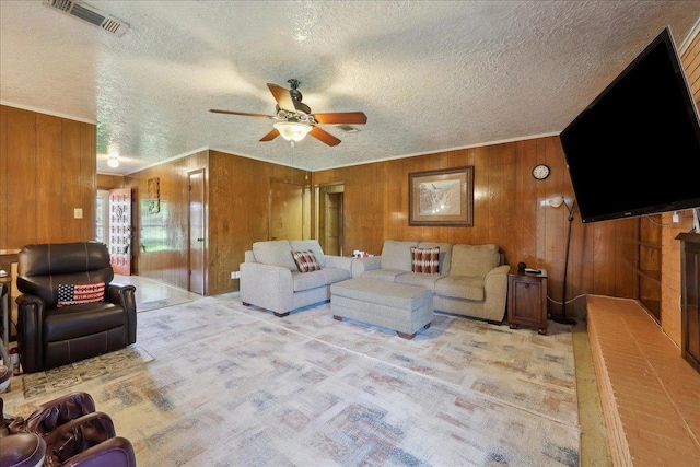 7760 Laurie Ln, Lumberton, TX 77657 - living area featuring wood walls, a ceiling fan, a textured ceiling, light carpet, and crown molding