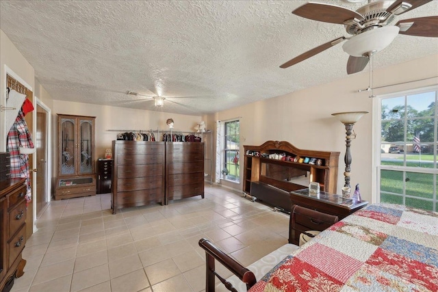 7760 Laurie Ln, Lumberton, TX 77657 - bedroom with light tile patterned floors, a textured ceiling, and a ceiling fan