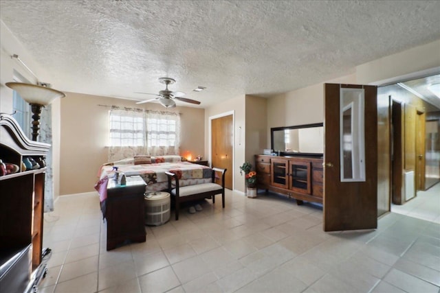 7760 Laurie Ln, Lumberton, TX 77657 - bedroom with light tile patterned floors, a textured ceiling, baseboards, and a ceiling fan