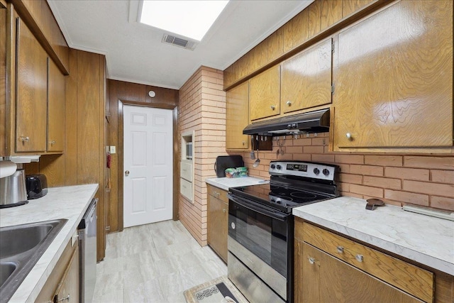 7760 Laurie Ln, Lumberton, TX 77657 - kitchen with appliances with stainless steel finishes, under cabinet range hood, decorative backsplash, light countertops, and brown cabinets