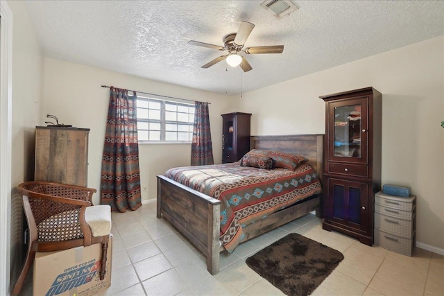 7760 Laurie Ln, Lumberton, TX 77657 - bedroom with a textured ceiling, light tile patterned floors, ceiling fan, and baseboards