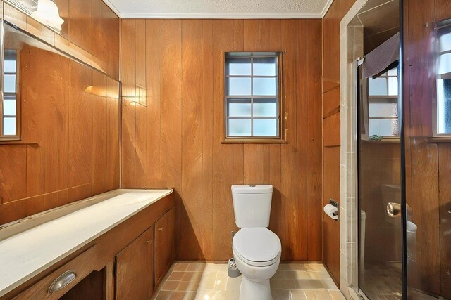 7760 Laurie Ln, Lumberton, TX 77657 - full bath with toilet, a stall shower, ornamental molding, vanity, and wooden walls