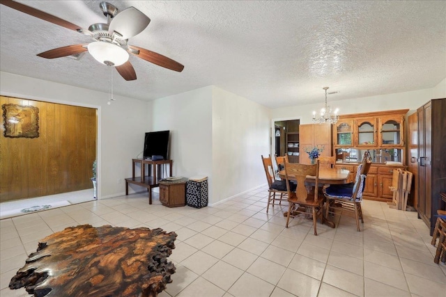 7760 Laurie Ln, Lumberton, TX 77657 - dining room featuring a chandelier, a textured ceiling, light tile patterned floors, baseboards, and a ceiling fan