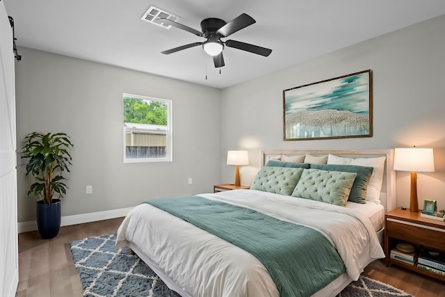 bedroom featuring wood finished floors, baseboards, and ceiling fan