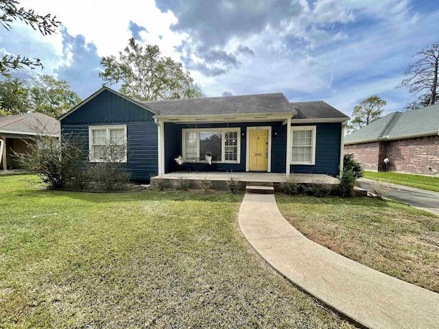 single story home featuring a front lawn and a porch