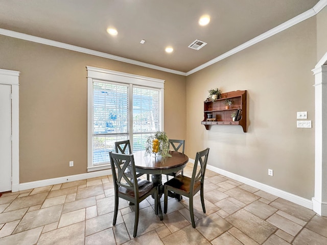 dining area featuring crown molding