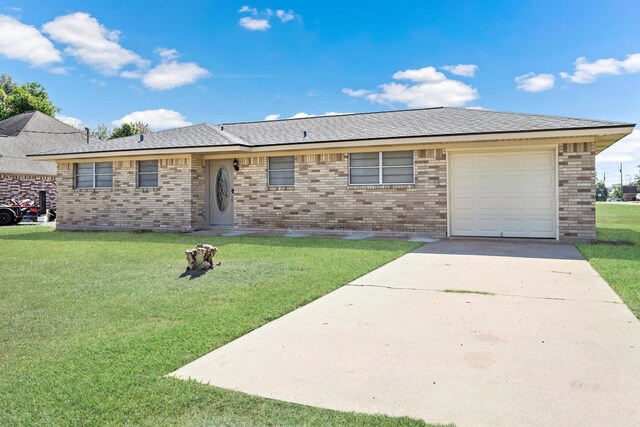 single story home featuring a garage and a front lawn