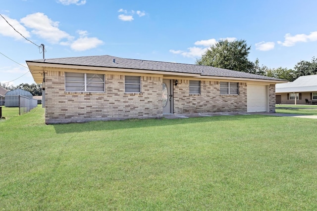 ranch-style home featuring a front lawn and a garage