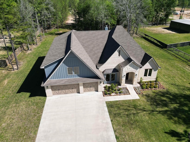 view of front of property featuring a front yard and a garage