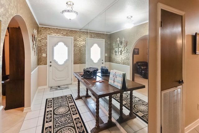 tiled foyer entrance with ornamental molding