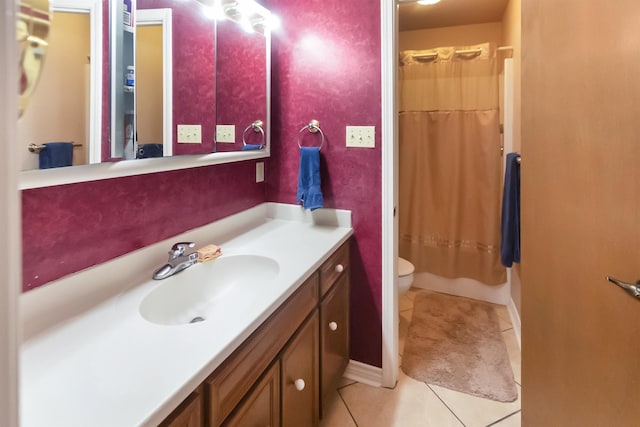 bathroom featuring toilet, vanity, tile patterned floors, and walk in shower