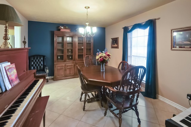 dining area featuring light tile patterned floors and an inviting chandelier