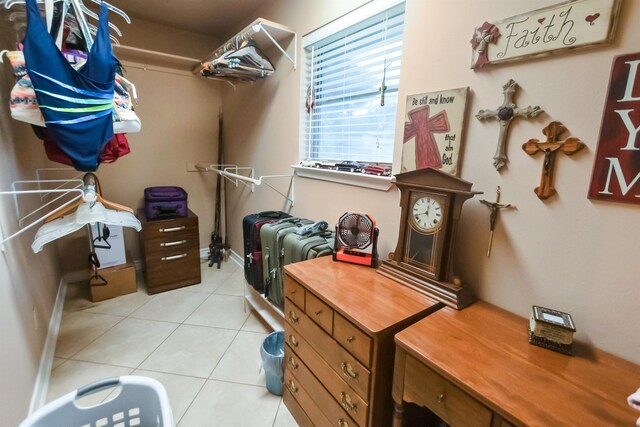 walk in closet with light tile patterned floors