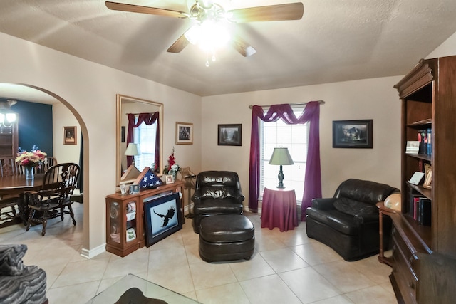 tiled living room featuring ceiling fan