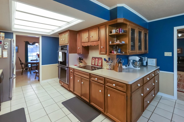 kitchen with black appliances, light tile patterned floors, and ornamental molding