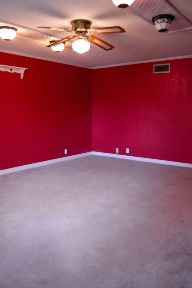 unfurnished room with carpet, ceiling fan, and ornamental molding