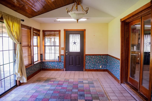 entrance foyer featuring tile patterned floors, wooden ceiling, and lofted ceiling