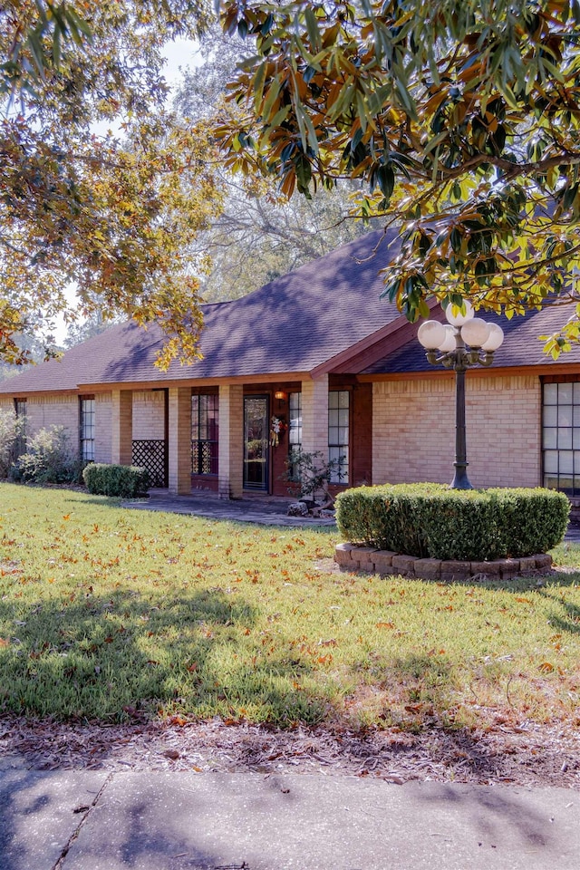 ranch-style home with a front lawn