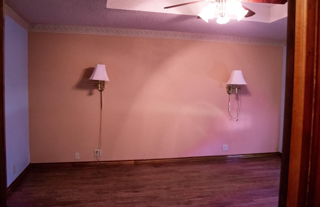 spare room with ceiling fan, dark hardwood / wood-style flooring, and a textured ceiling