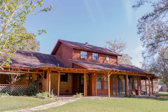 view of front facade featuring a front lawn and a sunroom