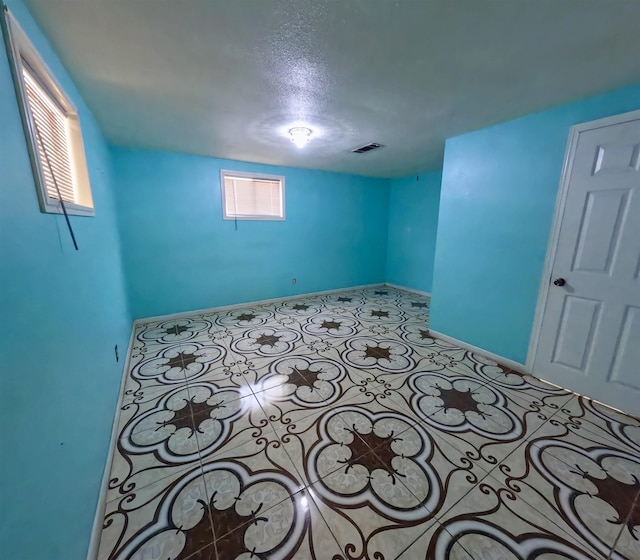 basement featuring light tile patterned floors