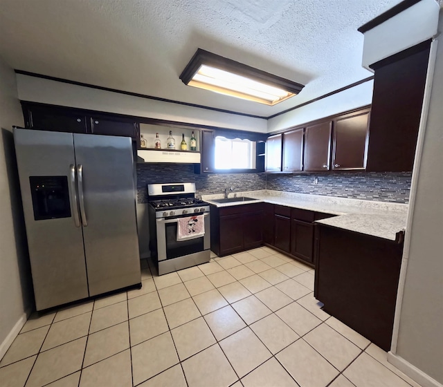 kitchen with light tile patterned floors, decorative backsplash, and appliances with stainless steel finishes