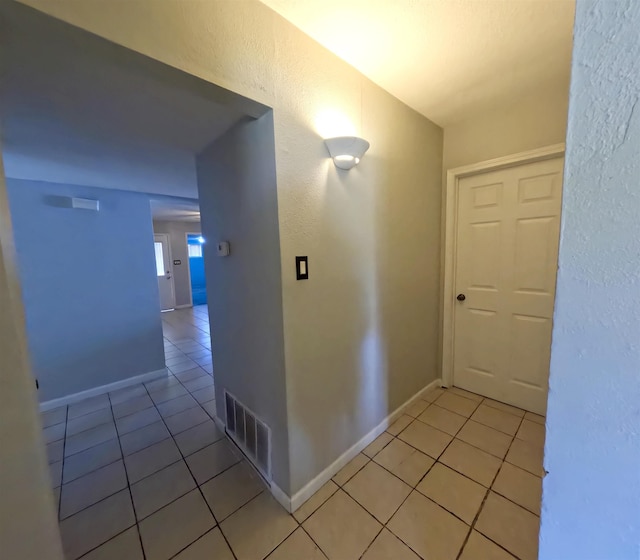 corridor featuring light tile patterned floors