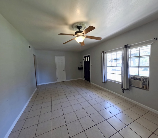 tiled empty room with cooling unit and ceiling fan