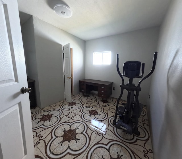 exercise room featuring light tile patterned floors