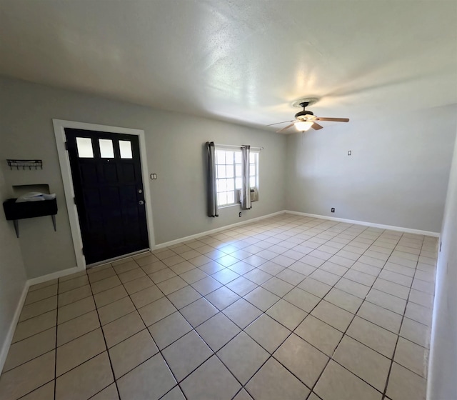 tiled foyer featuring ceiling fan