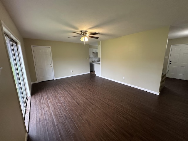 2390 Sarah St, Beaumont, TX 77705 - unfurnished living room featuring ceiling fan, dark wood finished floors, and baseboards
