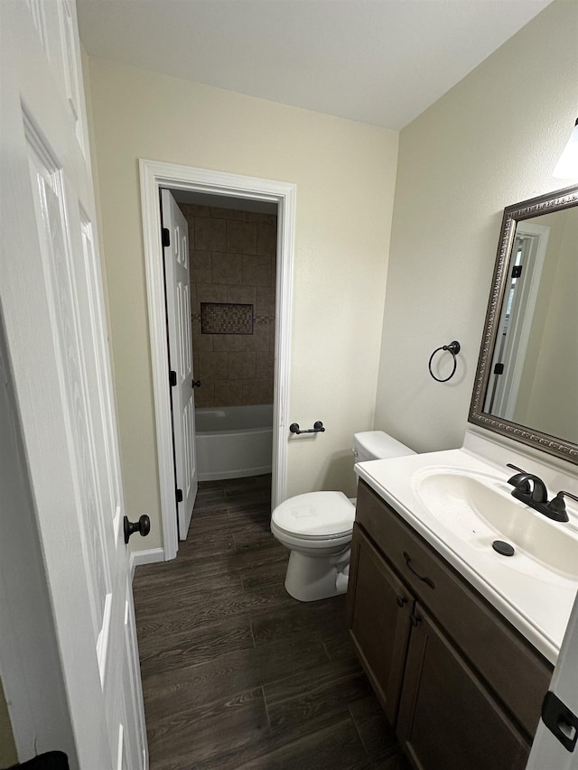 2390 Sarah St, Beaumont, TX 77705 - full bathroom with vanity, toilet, wood finished floors, a tub, and a shower