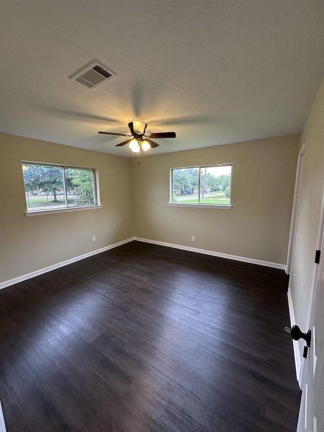2390 Sarah St, Beaumont, TX 77705 - empty room featuring plenty of natural light, dark wood-type flooring, and baseboards