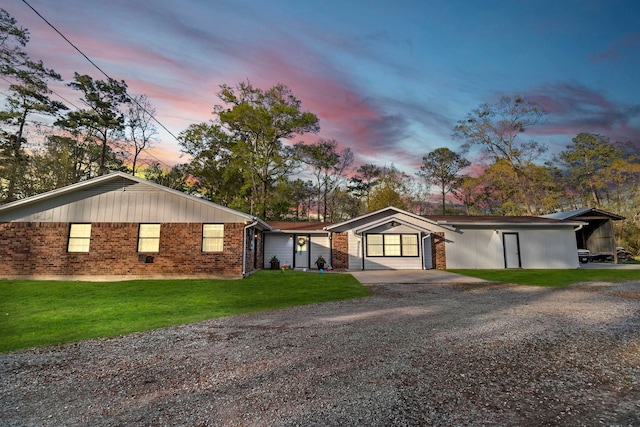 ranch-style house with gravel driveway and a front lawn