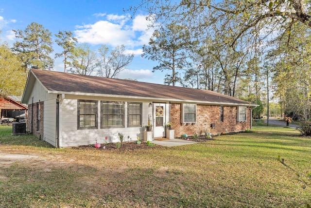 single story home featuring central air condition unit and a front lawn