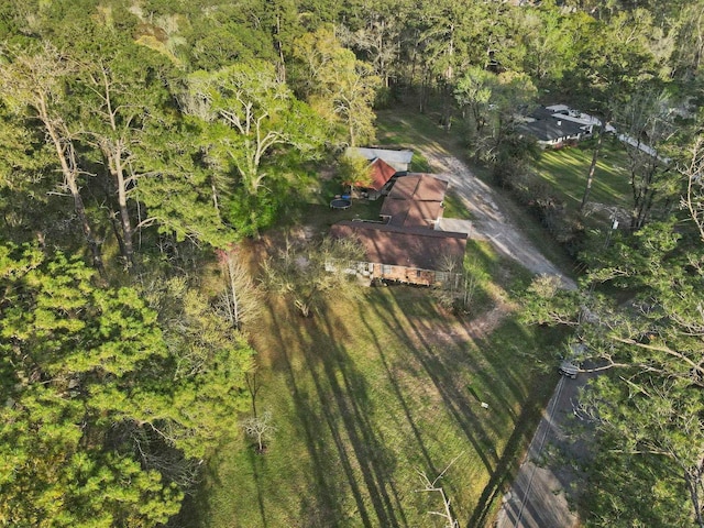 drone / aerial view featuring a wooded view