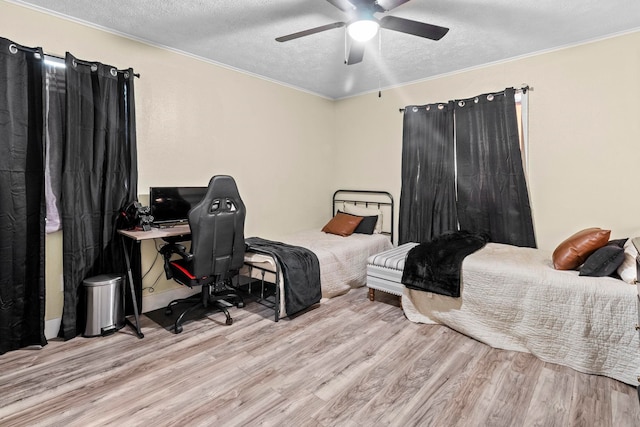 bedroom with a textured ceiling, wood finished floors, and crown molding